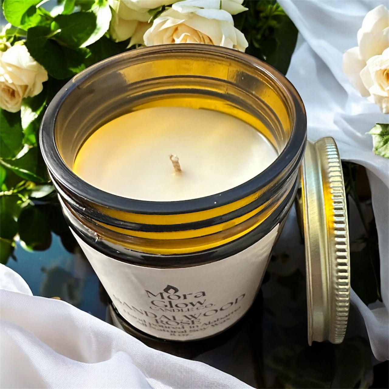 8oz Sandalwood Rose candle is a amber jar and gold lid. Smooth clean natural soy wax with a cotton wick, explore the calm and cozy aroma.